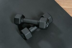 Dumbbells on a yoga mat for home workouts